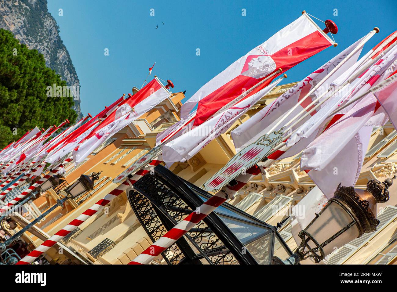 Flags celebrating 70 years of the Monaco Yacht Club in Monaco old town Stock Photo