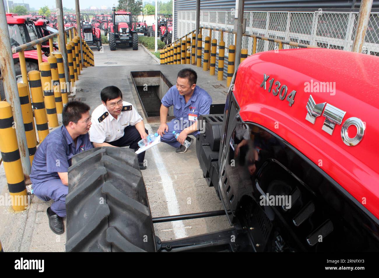 A customs officer checks a Dongfanghong tractor in Luoyang, central