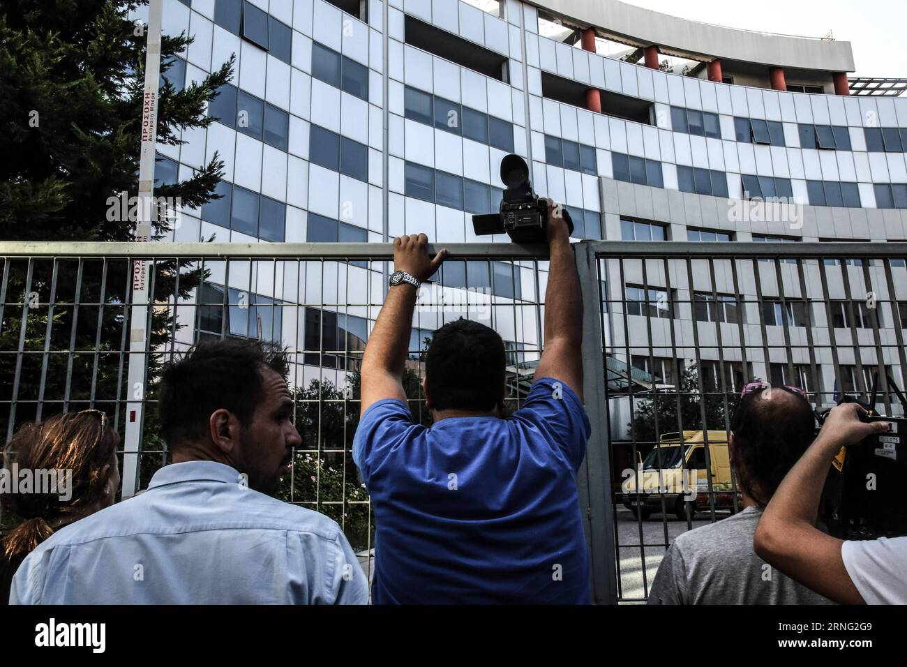 A cameraman stands outside the main entrance of the building of Greek General Secretariat of Information and Communication in Athens, Greece, on Sept. 1, 2016. Greece ended Friday a much-debated marathon auction for four licenses of TV broadcasting nationwide, which were tendered to business moguls and private media companies. ) GREECE-ATHENS-TV LICENSE-TENDER LefterisxPartsalis PUBLICATIONxNOTxINxCHN   a cameraman stands outside The Main Entrance of The Building of Greek General Secretariat of Information and Communication in Athens Greece ON Sept 1 2016 Greece ended Friday a Much debated Mar Stock Photo