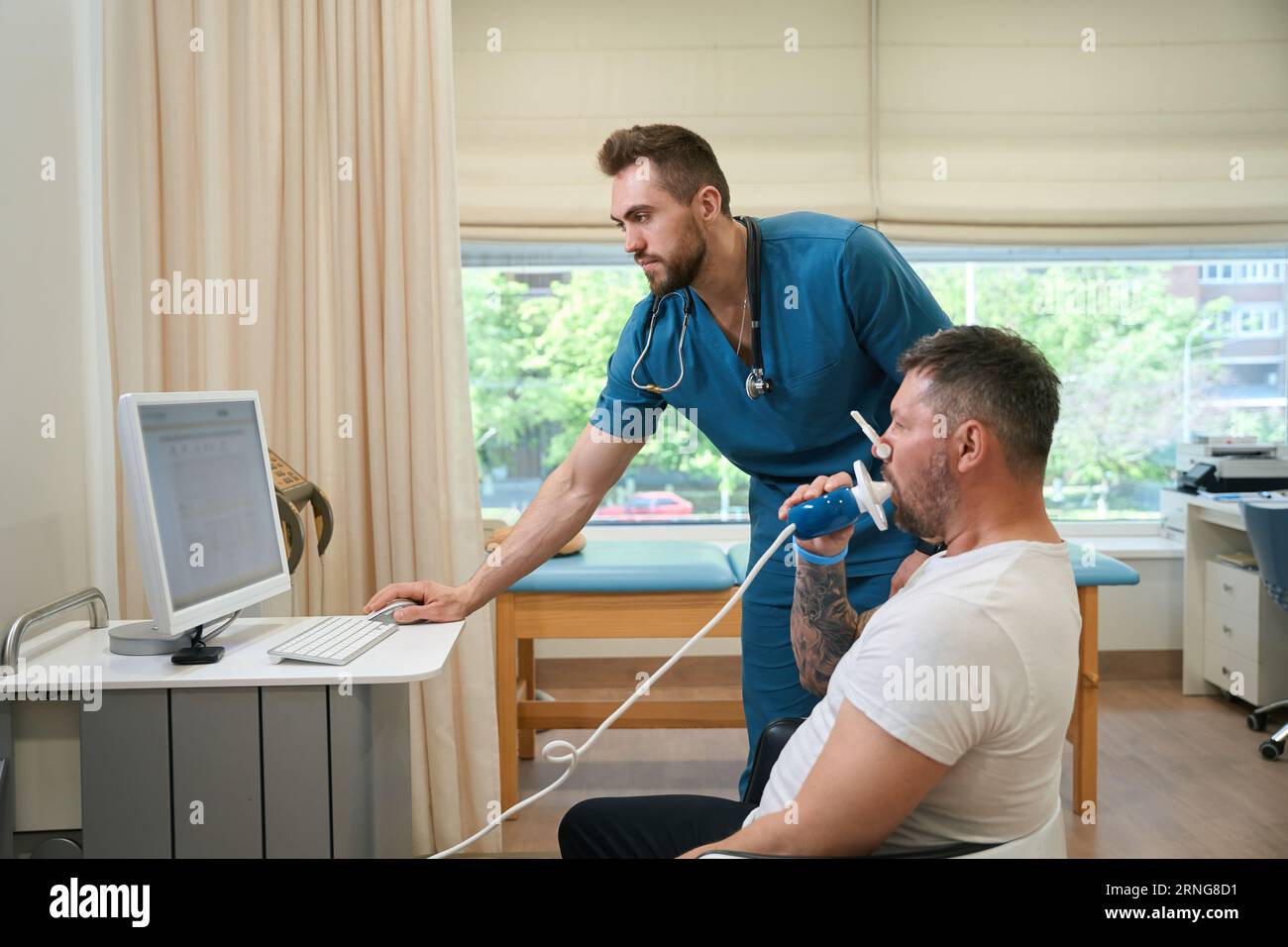 Pulmonologist monitoring patient lung function during spirometry test