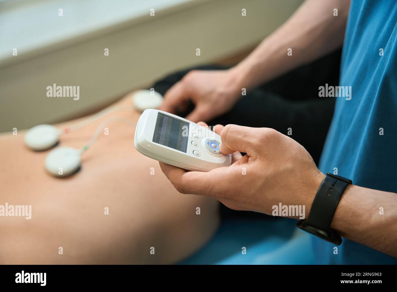 https://c8.alamy.com/comp/2RNG963/physiotherapist-performing-electrical-muscle-stimulation-on-adult-patient-2RNG963.jpg