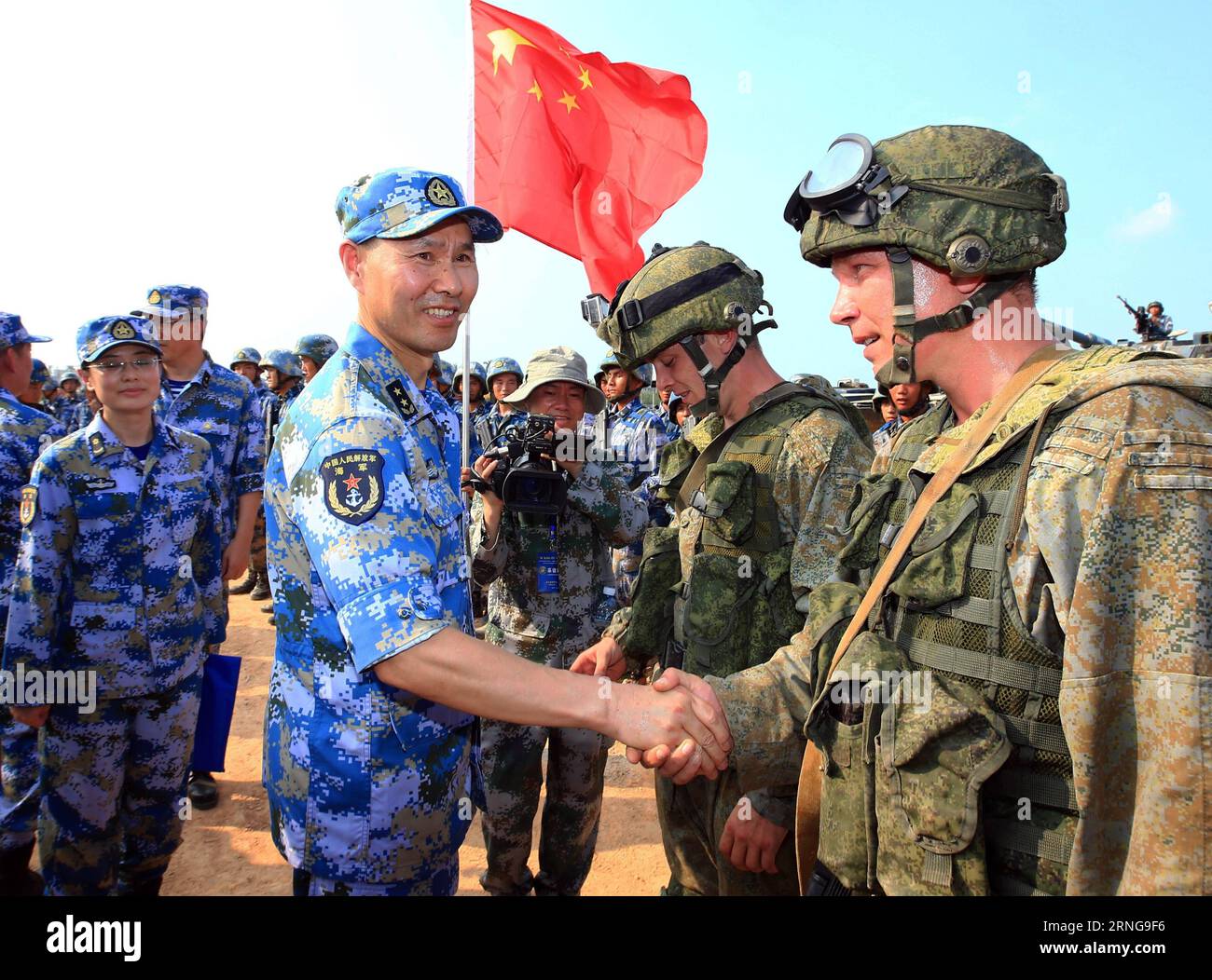 (160914) -- ZHANJIANG, Sept. 14, 2016 -- Wang Hai, Chinese chief director of the exercise and deputy commander of the Chinese Navy, shakes hands with Russian marines during a joint naval drill in Zhanjiang, south China s Guangdong Province, Sept. 14, 2016. China and Russia started Joint Sea 2016 drill off Guangdong Province in the South China Sea on Tuesday. The drill will run until Sept. 19, featuring navy surface ships, submarines, fixed-wing aircraft, helicopters, marines and amphibious armored equipment. ) (wyo) CHINA-RUSSIA-JOINT NAVAL DRILL (CN) ZhaxChunming PUBLICATIONxNOTxINxCHN   1609 Stock Photo