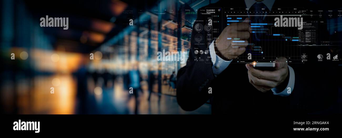 Project management team updating planning schedule with Gantt chart on