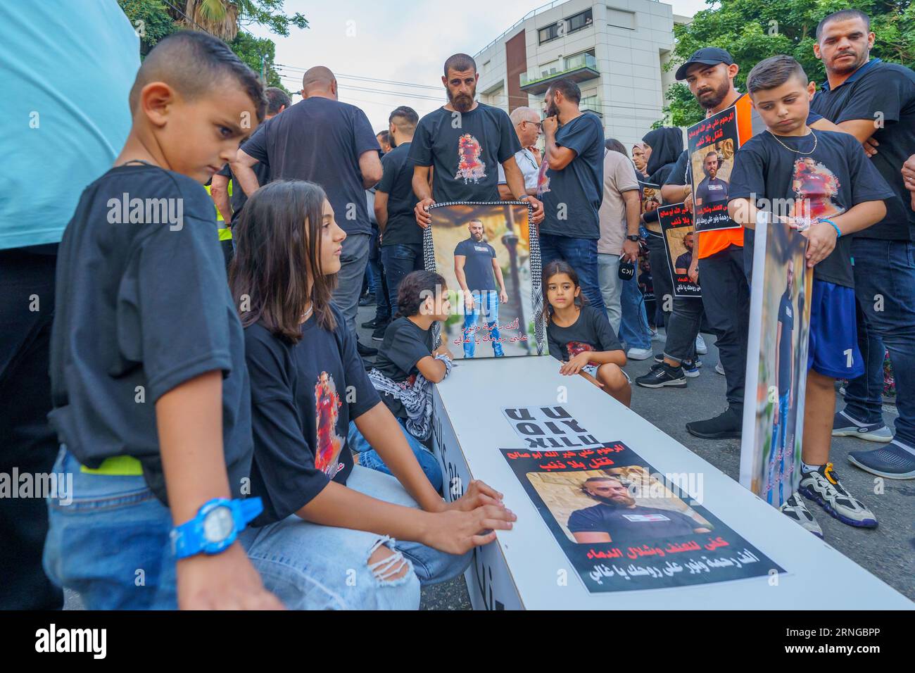 Haifa, Israel - August 31, 2023: People with pictures of their loved ones, part of the march of the dead protest against rising violence and murder ra Stock Photo