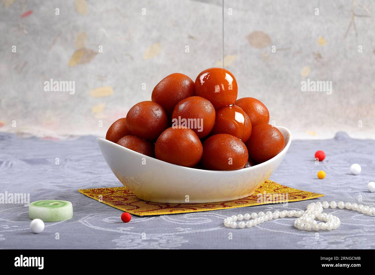 Sweet Gulab Jamun served in White bowl, Famous Indian and Pakistani dessert sweets isolated indoor studio background Stock Photo