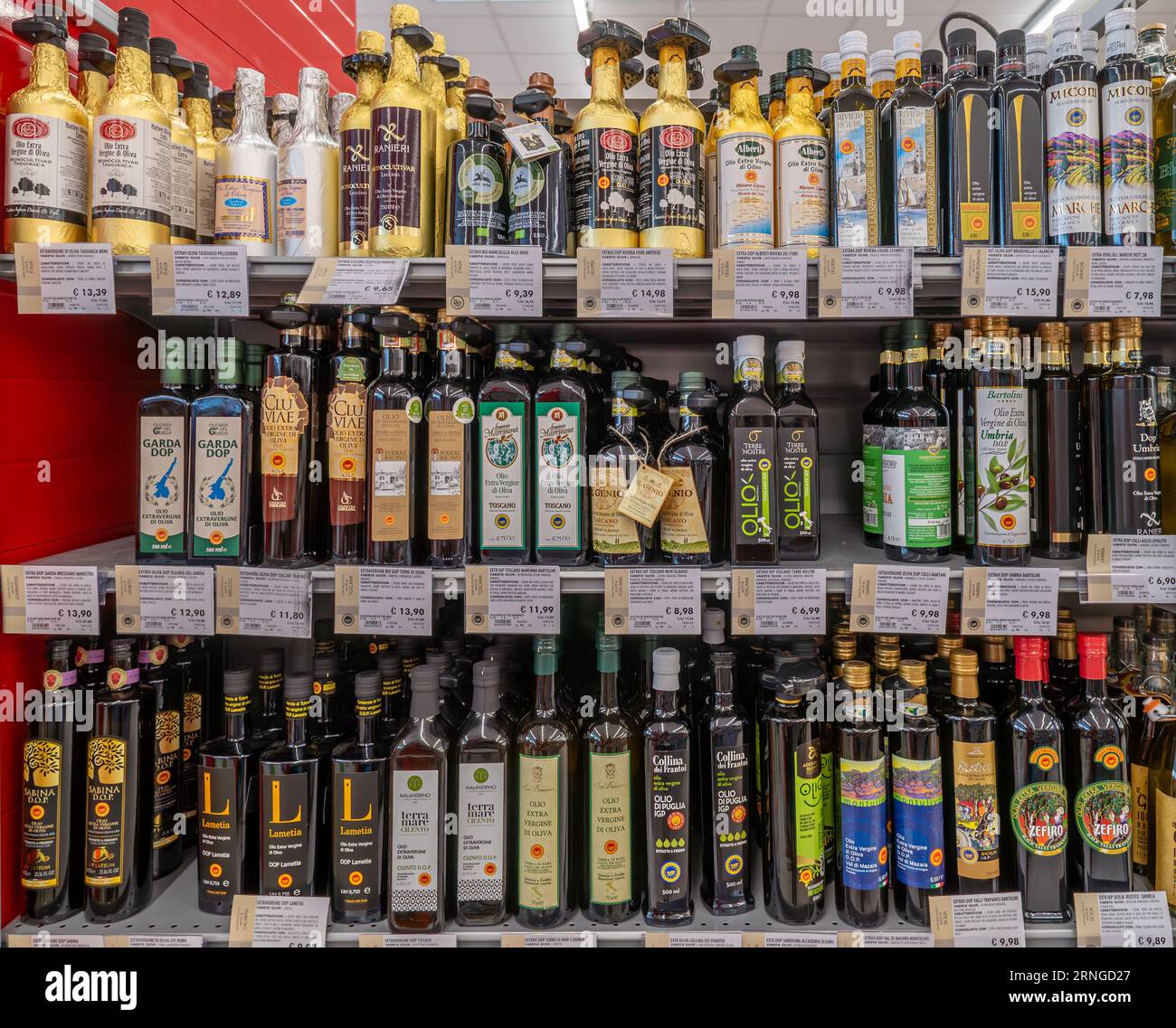 Italy - 14 August 2023: High-quality Italian extra virgin olive oil in bottles from different producers on the shelves for sale in an Italian supermar Stock Photo