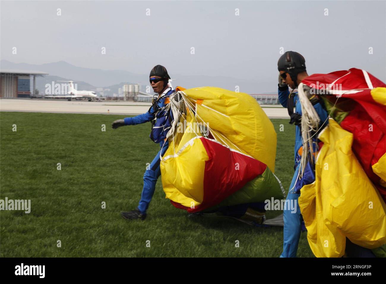 (160925) -- PYONGYANG, Sept. 25, 2016 -- Parachutists land after performance during an international air show in Wonsan, the Democratic People s Republic of Korea (DPRK), on Sept. 25, 2016, the second day of the international air show. The Wonsan International Friendship Air Festival, the first of its kind in the DPRK, runs from Saturday through Sunday at Kalma International Airport, which was redesigned and reconstructed from a military airfield to promote tourism. ) (cl) DPRK-WONSAN-INTERNATIONAL AIR SHOW ZhuxLongchuan PUBLICATIONxNOTxINxCHN   Pyongyang Sept 25 2016 parachutistsperson Parach Stock Photo