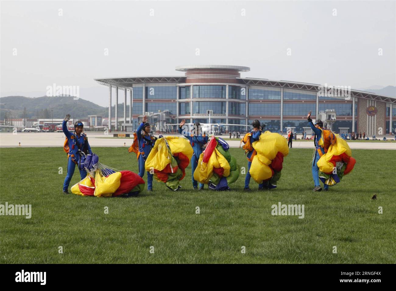 (160925) -- PYONGYANG, Sept. 25, 2016 -- Parachutists land after performance during an international air show in Wonsan, the Democratic People s Republic of Korea (DPRK), on Sept. 25, 2016, the second day of the international air show. The Wonsan International Friendship Air Festival, the first of its kind in the DPRK, runs from Saturday through Sunday at Kalma International Airport, which was redesigned and reconstructed from a military airfield to promote tourism. ) (cl) DPRK-WONSAN-INTERNATIONAL AIR SHOW ZhuxLongchuan PUBLICATIONxNOTxINxCHN   Pyongyang Sept 25 2016 parachutistsperson Parach Stock Photo