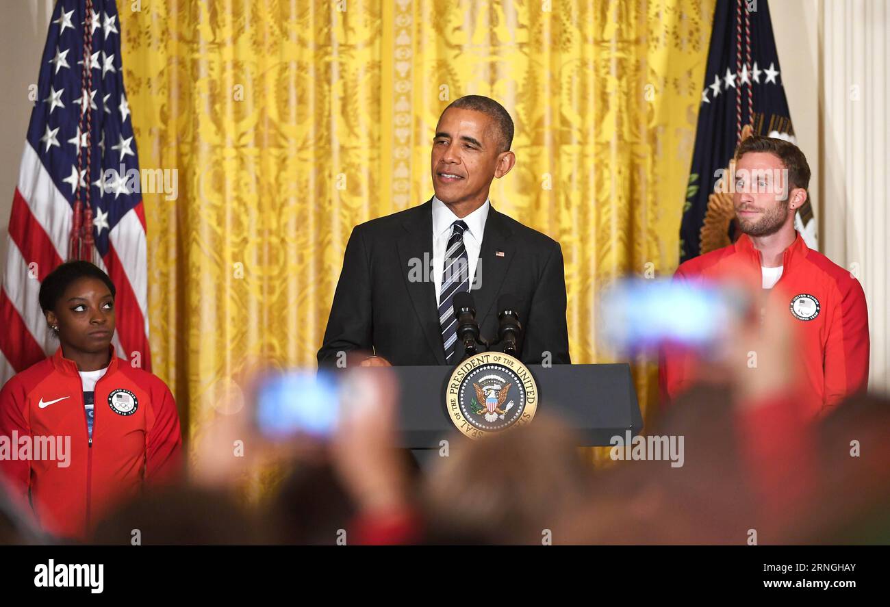 WASHINGTON D.C., Sept. 29, 2016 -- U.S. President Barack Obama (C), Olympic gymnast Simone Biles (L) and Paralympic athlete Josh Brunais attend a ceremony honoring members of the 2016 U.S. Olympic and Paralympic Teams in the East Room of White House in Washington D.C., the United States, Sept. 29, 2016. ) (SP)U.S.-WASHINGTON D.C.-OLY2016-OBAMA YinxBogu PUBLICATIONxNOTxINxCHN   Washington D C Sept 29 2016 U S President Barack Obama C Olympic Gymnast Simone Biles l and Paralympics Athlete Josh  attend a Ceremony honoring Members of The 2016 U S Olympic and Paralympics Teams in The East Room of W Stock Photo