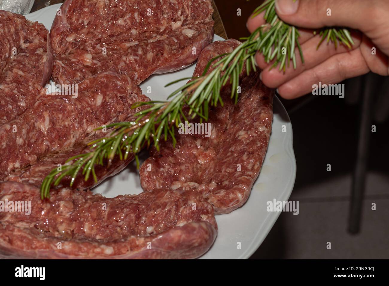 Fire Up the Flavor: A Variety of Meats and Sausages Ready to Sizzle on the Barbecue Stock Photo