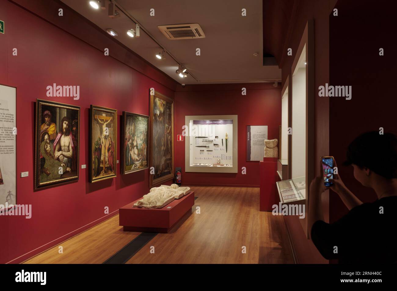 child taking a photo with a mobile phone, smartphone, in a room of the provincial museum, Palacio del Infantado, in the city of Guadalajara, Spain. Stock Photo