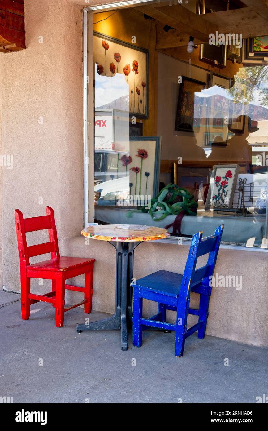 Colorful chairs outside picture window display of gallery in historic ...
