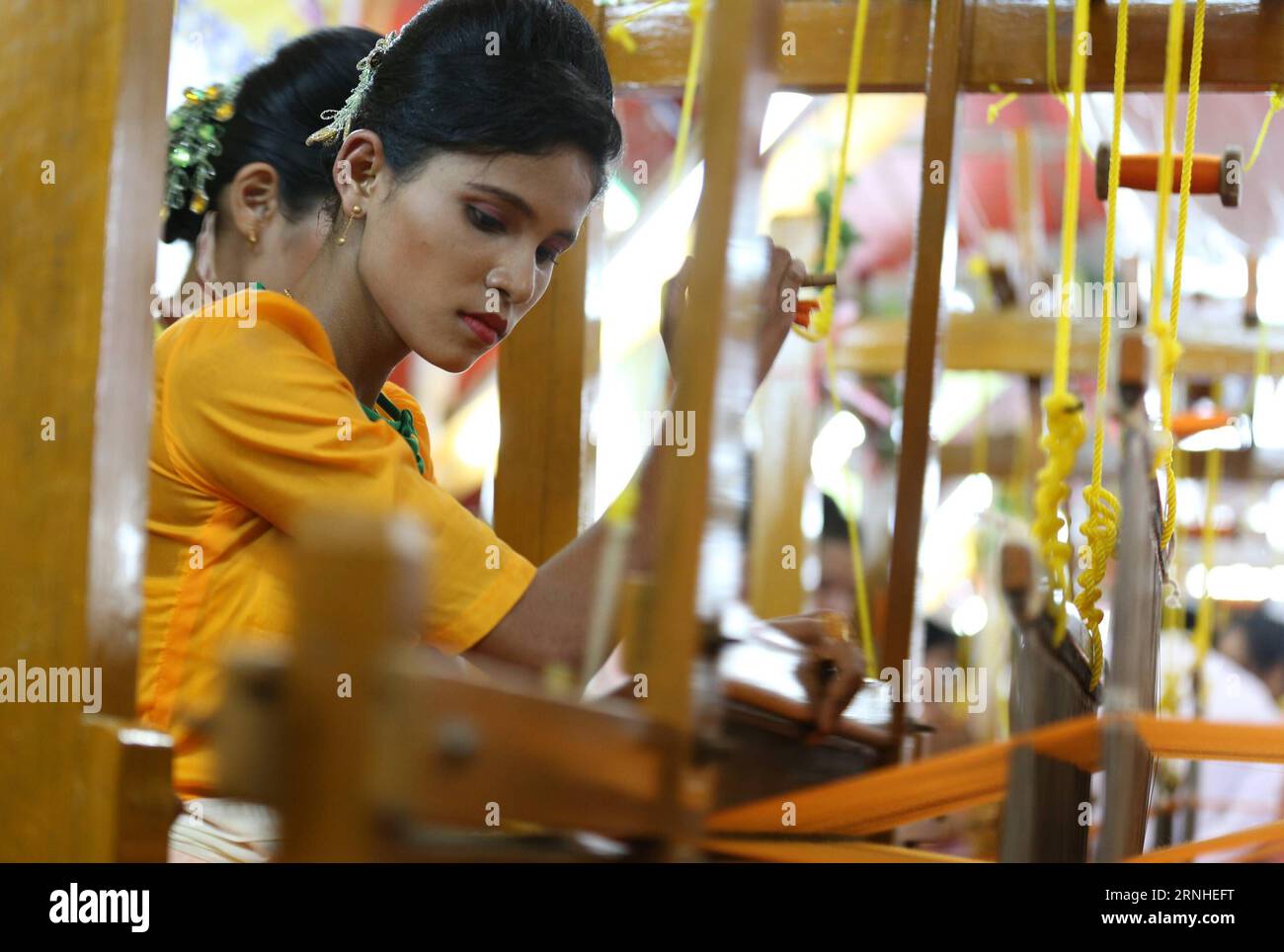Women compete weaving robes at Shwedagon Pagoda in Yangon, Myanmar, Nov