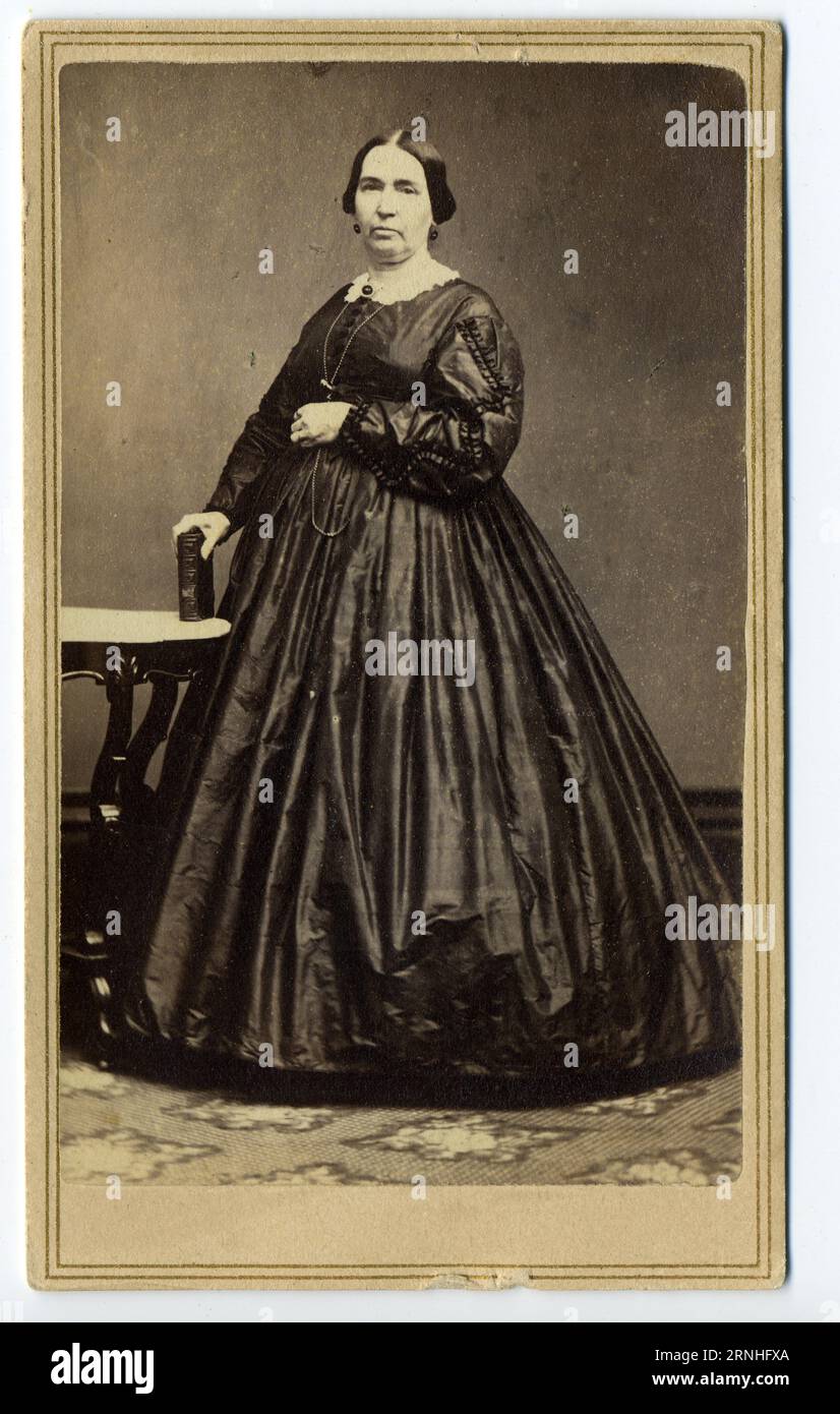 A 19th century carte de visite photograph of an American  woman wearing a full-skirted dress, fashionable in the 1860s. Stock Photo