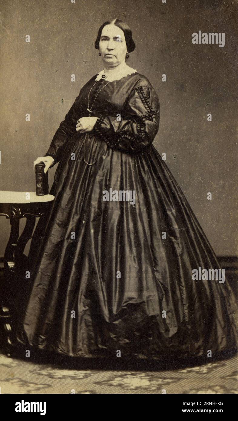 A 19th century carte de visite photograph of an American  woman wearing a full-skirted dress, fashionable in the 1860s. Stock Photo