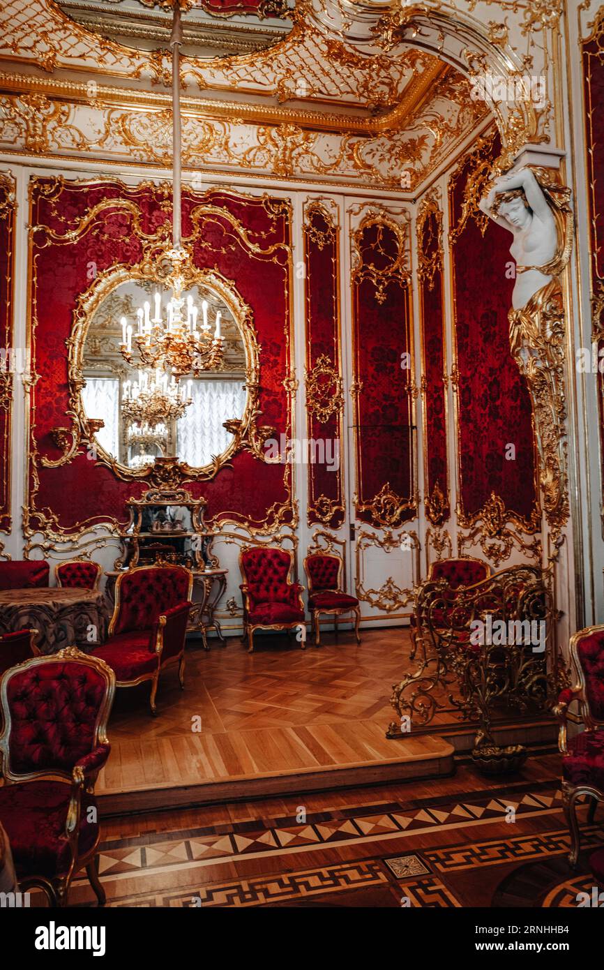 Royal historical golden red interior with armchairs, chandelier and furniture in the famous Hermitage Museum in St. Petersburg city Stock Photo