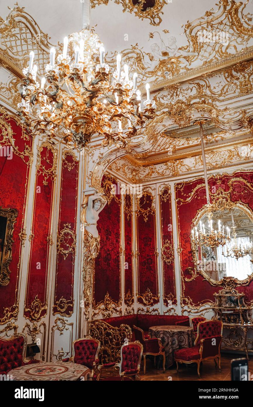 Royal historical red golden interior with armchairs, chandelier and furniture in the famous Hermitage Museum in St. Petersburg city Stock Photo
