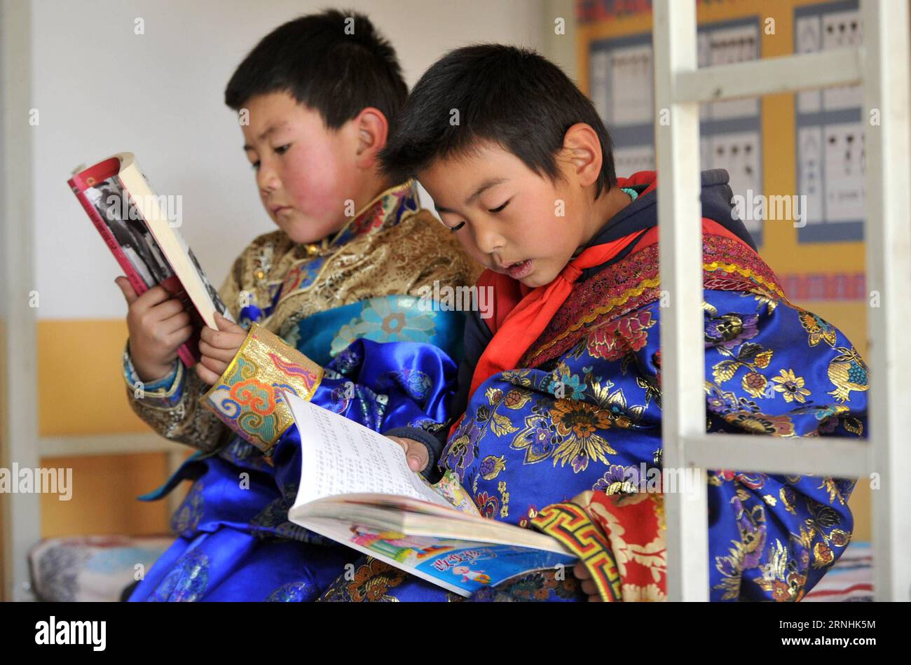 Pupils read books in their dormitory at Daiqian school in Zhuaxixiulong Township of Tianzhu Tibetan Autonomous County, northwest China s Gansu Province, Nov. 24, 2016. To increase the enrollment rate of schools, especially ensure Tibetan children s access to education, about 62 schools of the county have concentrated the efforts in training teachers and attracting more competent faculties as well as improving conditions for teaching facilities. ) (wsw) CHINA-GANSU-EDUCATION-IMPROVEMENT (CN) Guoxgang PUBLICATIONxNOTxINxCHN   Pupils Read Books in their Dormitory AT  School in  Township of Tianzh Stock Photo