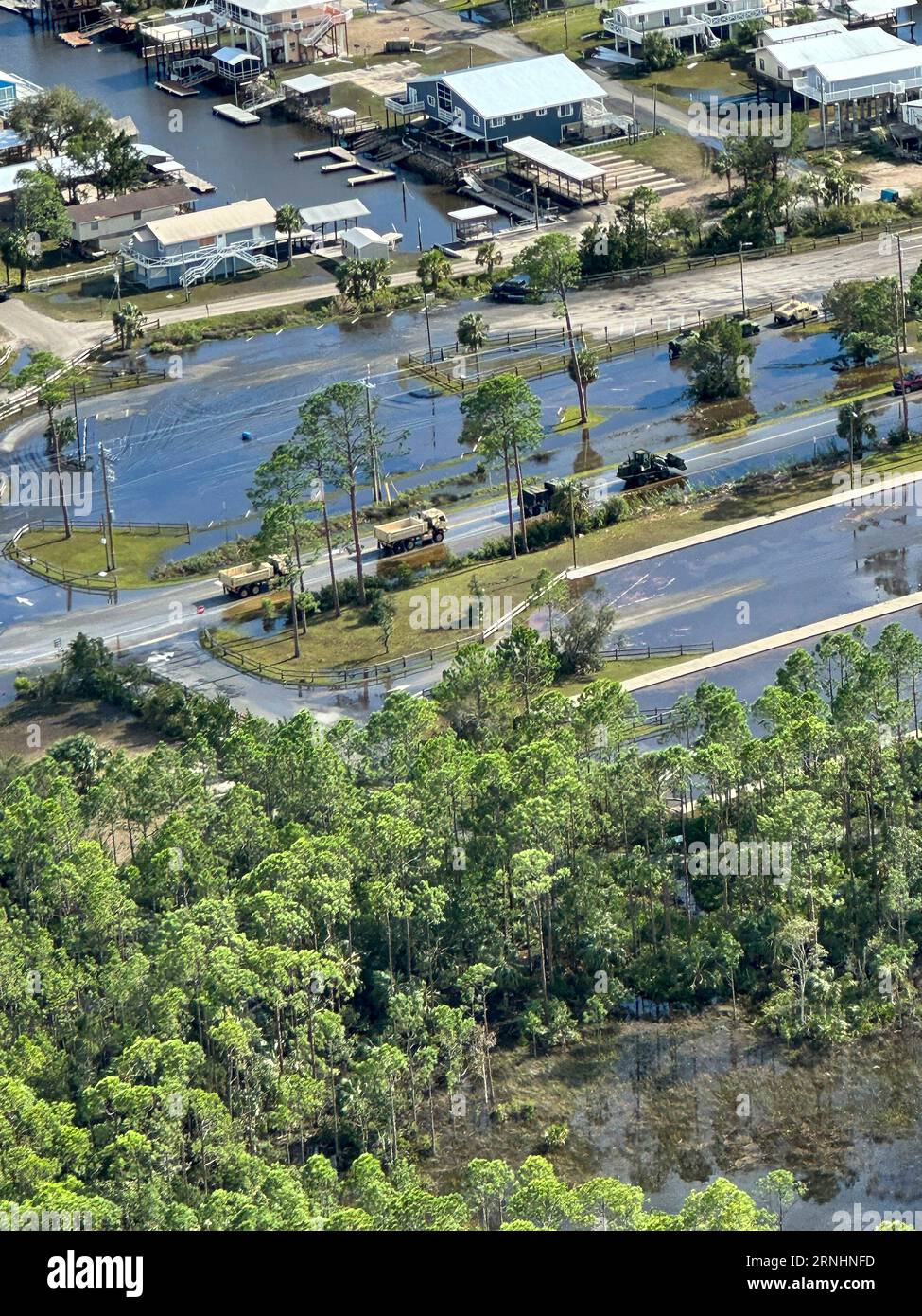 Dunedin, United States. 30th Aug, 2023. U.S Army convoy with the Florida National Guard, 53d Infantry Brigade Combat Team, travels through flooded streets to check on residents in the aftermath of Hurricane Idalia, August 30, 2023 in Dunedin, Florida. Credit: SSgt. Cassandra Vieira/U.S Army/Alamy Live News Stock Photo