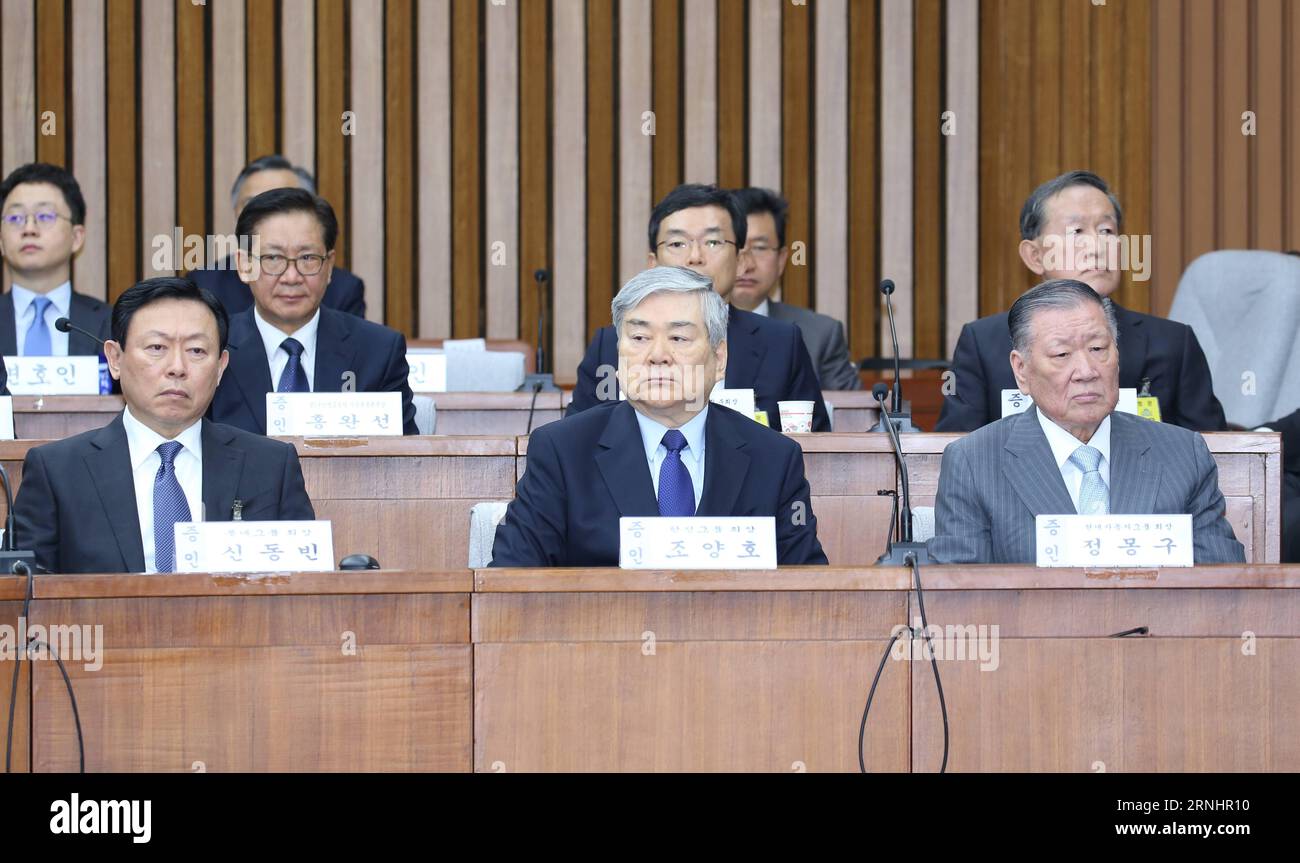 (161206) -- SEOUL, Dec. 6, 2016 -- Lotte Group Chairman Shin Dong-Bin, Hanjin Group Chairman Cho Yang-ho and Hyundai Motor Chairman Chung Mong-koo (front, L to R) attend the first parliamentary hearing for a scandal involving President Park Geun-hye in Seoul, South Korea, Dec. 6, 2016. Chiefs of South Korea s major conglomerates on Tuesday attended the first parliamentary hearing for a scandal involving President Park Geun-hye, being reminiscent of the 1988 interrogation of chaebol heads over the country s deep-rooted collusive links between politicians and businessmen. ) (lrz) SOUTH KOREA-SEO Stock Photo