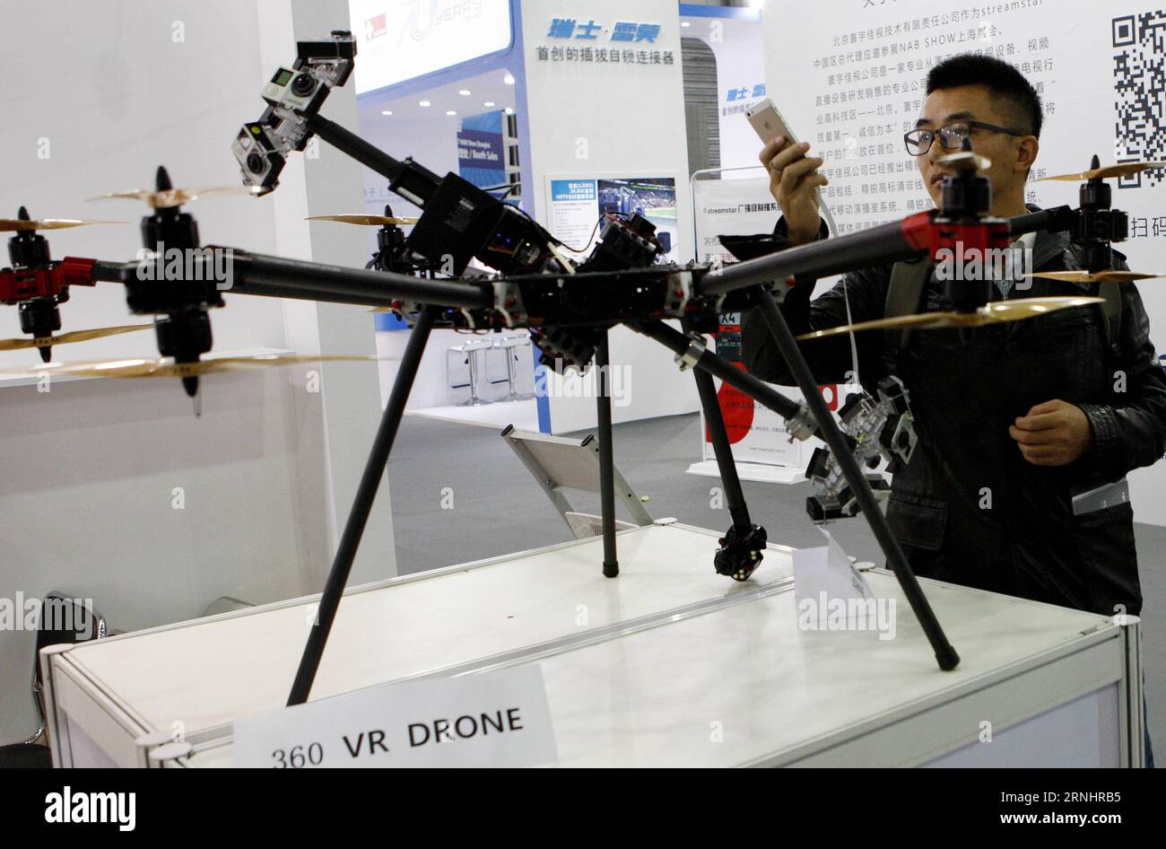 (161207) -- SHANGHAI, Dec. 7, 2016 -- A visitor takes photos of a 360 VR drone at the National Association of Broadcasters (NAB) Show Shanghai held in east China s Shanghai, Dec. 7, 2016. Building on the strength and success of the NAB Show brand and its global influence, Shanghai s show is the premier event for the broadcast and transmedia industry in the Asia and Pacific region. ) (wx) CHINA-SHANGHAI-NAB SHOW (CN) FangxZhe PUBLICATIONxNOTxINxCHN   Shanghai DEC 7 2016 a Visitor Takes Photos of a 360 VR Drone AT The National Association of Broadcasters NAB Show Shanghai Hero in East China S Sh Stock Photo