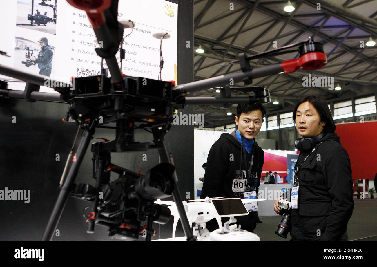 (161207) -- SHANGHAI, Dec. 7, 2016 -- Visitors view a drone with 4K high-definition camera at the National Association of Broadcasters (NAB) Show Shanghai held in east China s Shanghai, Dec. 7, 2016. Building on the strength and success of the NAB Show brand and its global influence, Shanghai s show is the premier event for the broadcast and transmedia industry in the Asia and Pacific region. ) (wx) CHINA-SHANGHAI-NAB SHOW (CN) FangxZhe PUBLICATIONxNOTxINxCHN   Shanghai DEC 7 2016 Visitors View a Drone With 4K High Definition Camera AT The National Association of Broadcasters NAB Show Shanghai Stock Photo