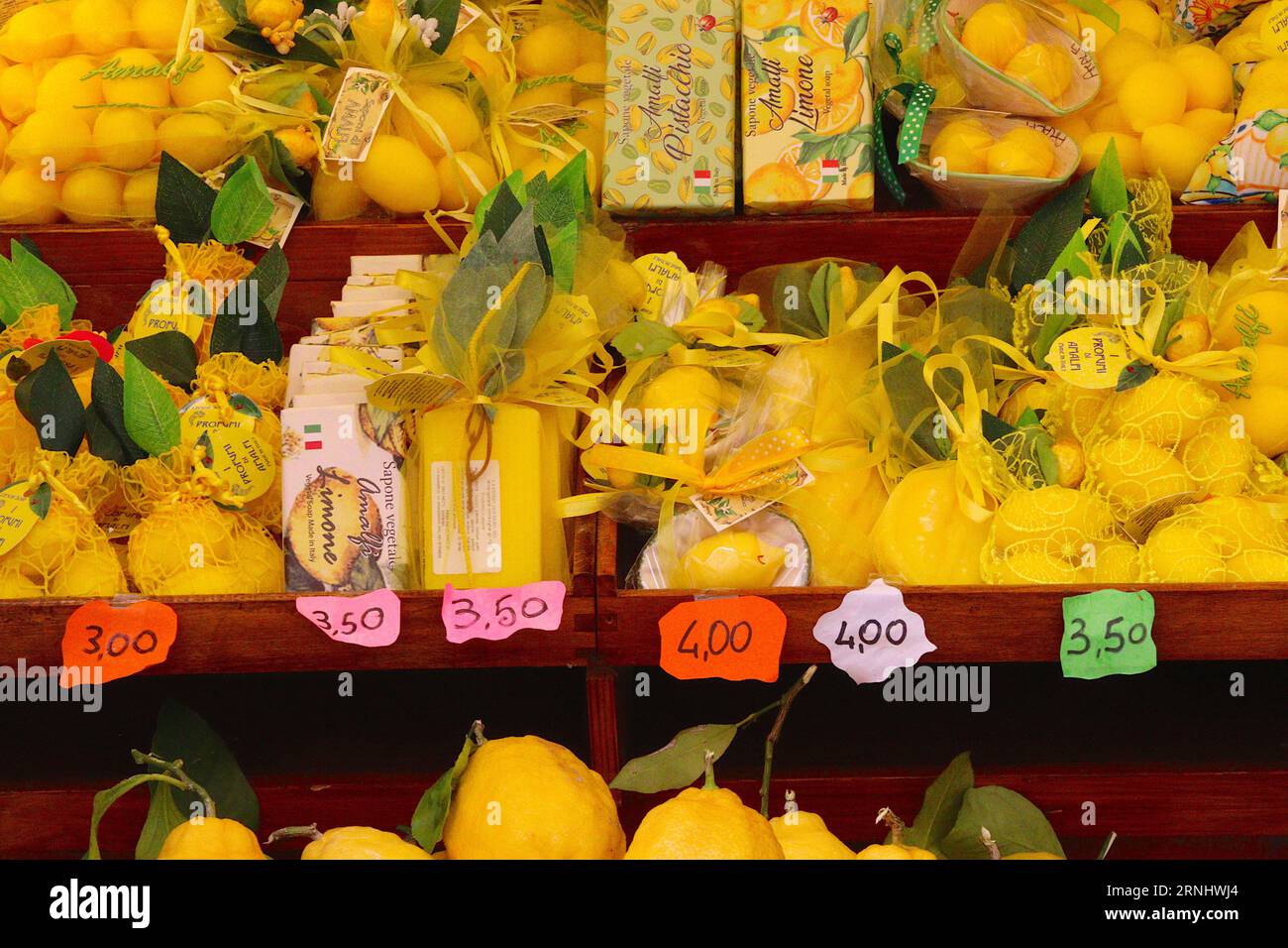 A n Italian trader specializing in a large variety of products and souvenirs based on Amalfi lemons displayed for sale at a shop in Amalfi, Italy. Stock Photo