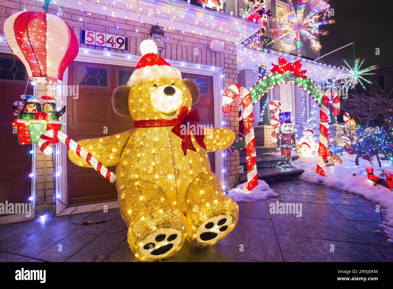 Colorful Christmas lights are seen in front of a residential house in