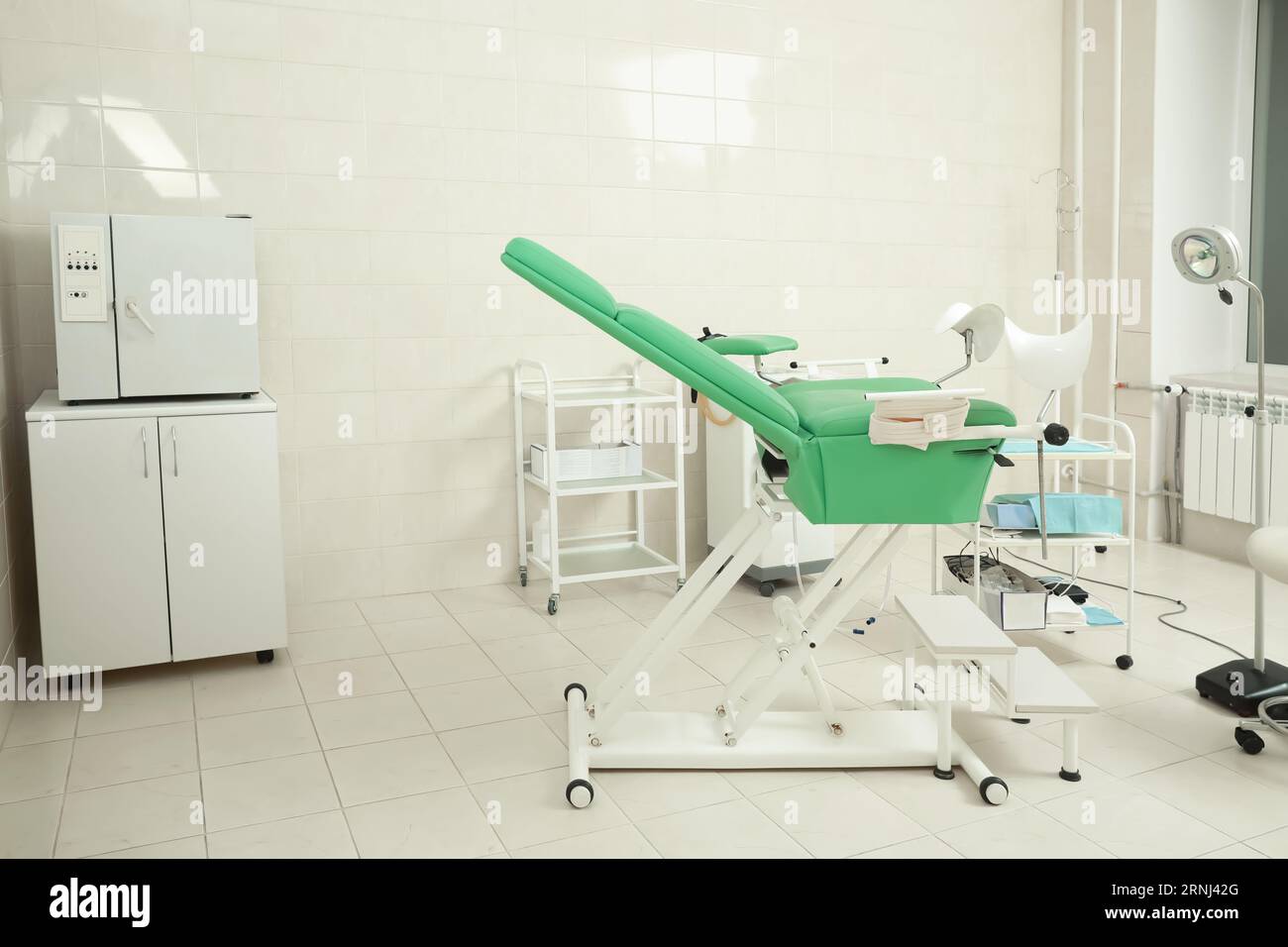 Modern gynecological office interior with examination chair and medical ...