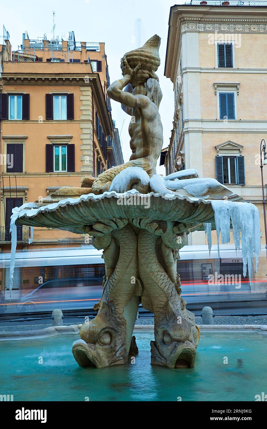 (170110) -- ROME, Jan. 10, 2017 -- Photo taken on Jan. 10, 2017 shows the Triton Fountain covered with ice at Piazza Barberini in central Rome, Italy. At least eight people died in Italy, as a wave of cold kept sweeping the country with freezing temperatures and heavy snowfalls on Monday. ) (sxk) ITALY-ROME-COLD WEATHER JinxYu PUBLICATIONxNOTxINxCHN   Rome Jan 10 2017 Photo Taken ON Jan 10 2017 Shows The Triton Fountain Covered With ICE AT Piazza Barberini in Central Rome Italy AT least Eight Celebrities died in Italy As a Wave of Cold Kept Sweeping The Country With freezing temperatures and H Stock Photo