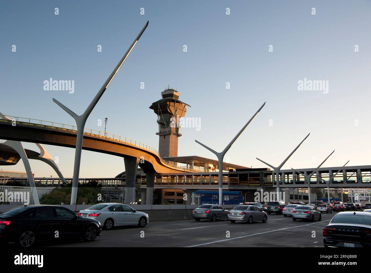 A newly added metro rail track coming into LAX partially obscures the view of the iconic Theme Building, Los Angeles, California, USA Stock Photo