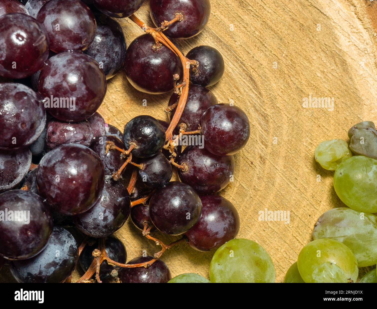 Grapes kishmish on a wooden background. The grapes are overripe