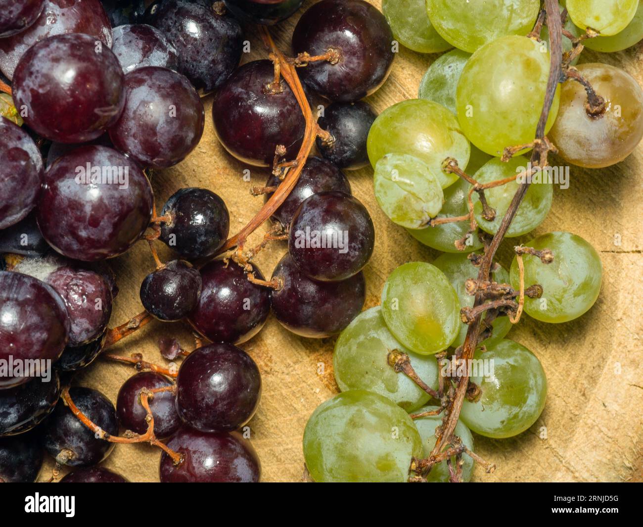 Grapes kishmish on a wooden background. The grapes are overripe ...