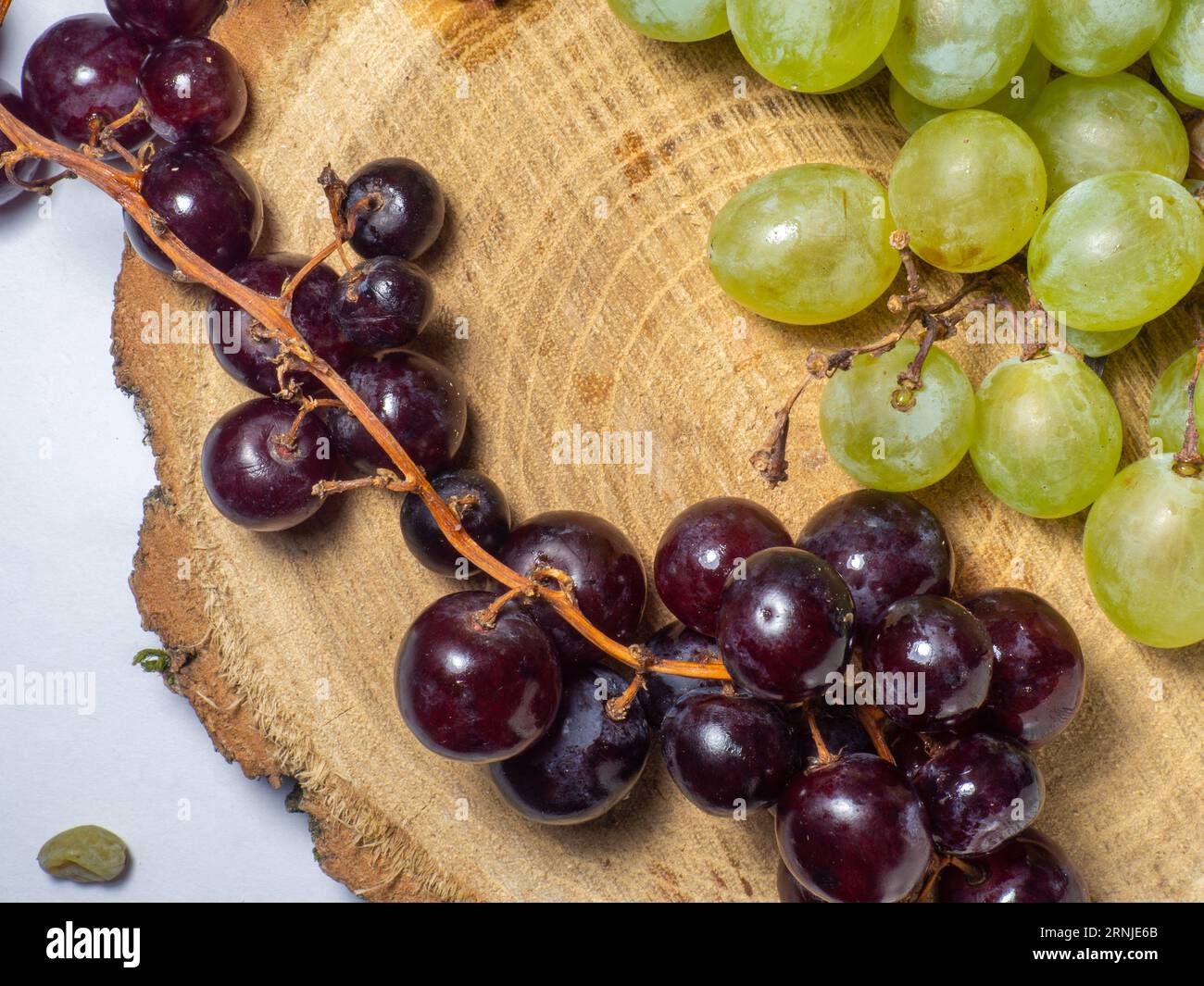 Grapes kishmish on a wooden background. The grapes are overripe