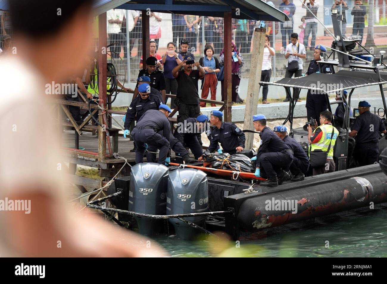 (170204) -- KOTA KINABALU, Feb. 4, 2017 () -- Staff members of Malaysian Maritime Enforcement Agency transfer a body in Kota Kinabalu, Malaysia, Feb. 4, 2017. A postmortem will be carried out to determine the identity of a female body, which was found on Saturday morning in waters near the Mengalum island, as the search for the missing from the Sabah sunken boat have been refocused on the area where the body was found. () (hy) MALAYSIA-KOTA KINABALU-SABAH SUNKEN BOAT xinhua PUBLICATIONxNOTxINxCHN   Kota Kinabalu Feb 4 2017 Staff Members of Malaysian Maritime Enforcement Agency Transfer a Body Stock Photo