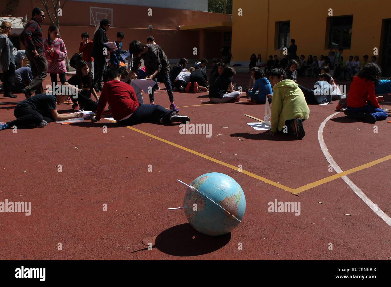 (170321) -- ATHENS, March 21, 2017 -- Greek students calculate the Earth s circumference at midday in Athens, Greece, March 20, 2017. Students in about 450 schools across Greece greeted on Monday the Spring Equinox which marks the beginning of the season, recalculating the Earth s circumference, repeating the experiment of the famous ancient Greek mathematician, astronomer and geographer Eratosthenes. ) (zjy) GREECE-ATHENS-STUDENT EXPERIMENT-EARTH S CIRCUMFERENCE-RECALCULATION MariosxLolos PUBLICATIONxNOTxINxCHN   Athens March 21 2017 Greek Students calculate The Earth S circumference AT midda Stock Photo