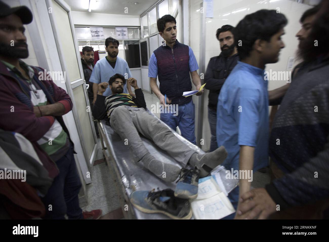 (170409) -- SRINAGAR, April 9, 2017 -- Paramedics transfer a wounded person inside a hospital in Srinagar, summer capital of Indian-controlled Kashmir, April 9, 2017. At least three persons were killed and several others injured on Sunday when Indian security forces opened fire on a stone-pelting mob that stormed a polling station in Indian-controlled Kashmir s parliamentary constituency of Srinagar. )(rh) KASHMIR-SRINAGAR-POLITICS JavedxDar PUBLICATIONxNOTxINxCHN   Srinagar April 9 2017 Paramedics Transfer a Wounded Person Inside a Hospital in Srinagar Summer Capital of Indian Controlled Kash Stock Photo