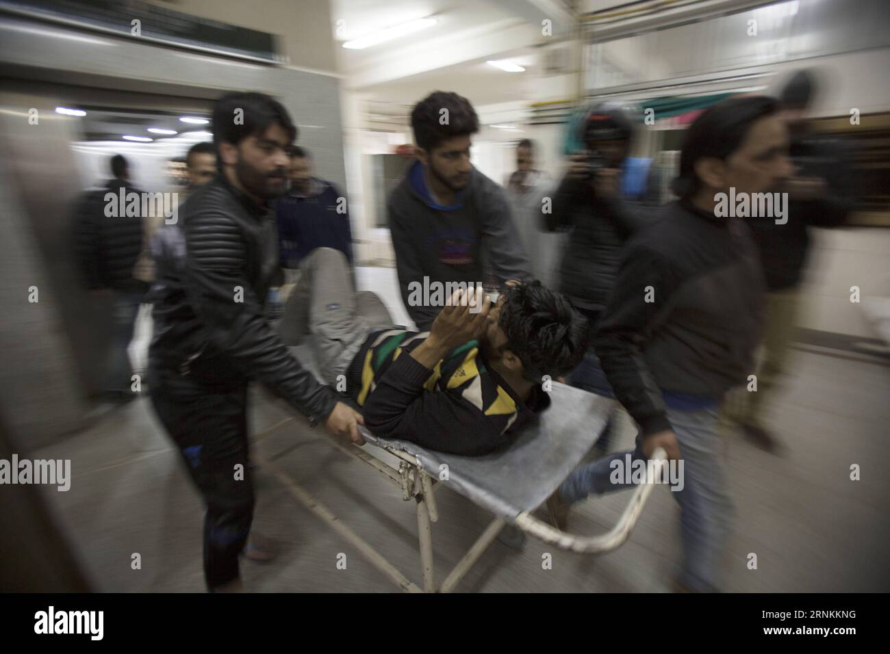 (170409) -- SRINAGAR, April 9, 2017 -- People transfer a wounded person inside a hospital in Srinagar, summer capital of Indian-controlled Kashmir, April 9, 2017. At least three persons were killed and several others injured on Sunday when Indian security forces opened fire on a stone-pelting mob that stormed a polling station in Indian-controlled Kashmir s parliamentary constituency of Srinagar. )(rh) KASHMIR-SRINAGAR-POLITICS JavedxDar PUBLICATIONxNOTxINxCHN   Srinagar April 9 2017 Celebrities Transfer a Wounded Person Inside a Hospital in Srinagar Summer Capital of Indian Controlled Kashmir Stock Photo