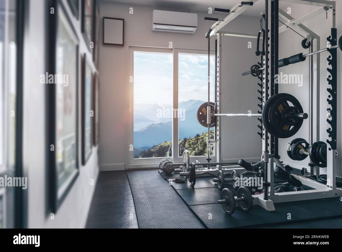 Cozy personal gym sport fitness weightlifeting room with beautiful mountain hill windows nature view Stock Photo