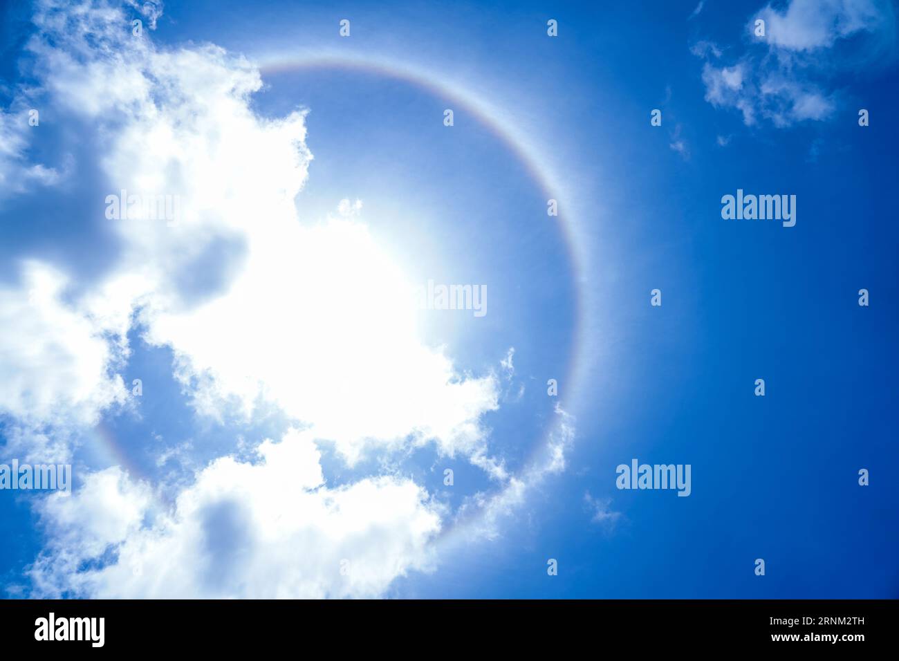 A halo formed around the Sun due to Cirrostratus clouds, composed of ice crystals Stock Photo