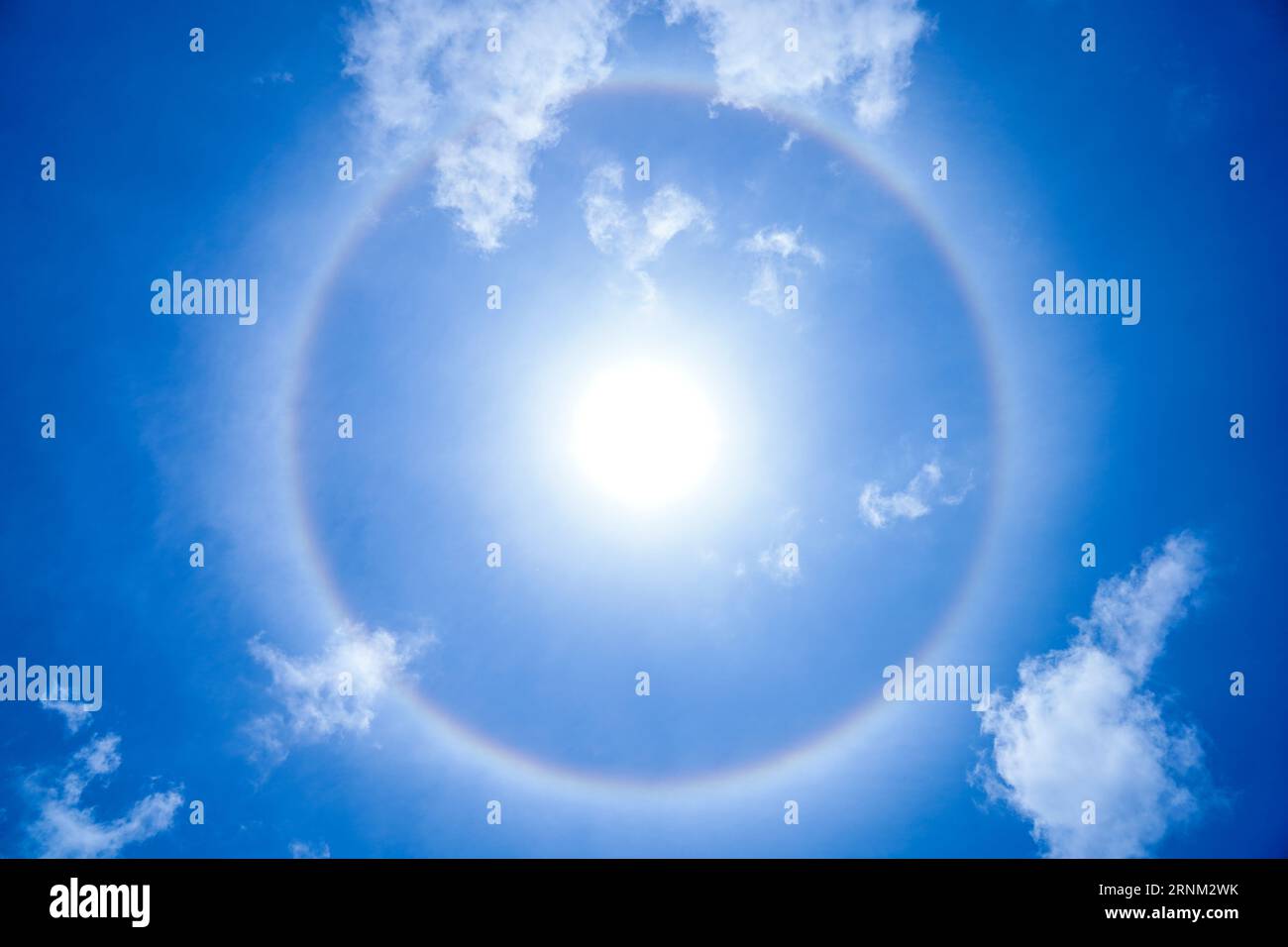 A halo formed around the Sun due to Cirrostratus clouds, composed of ice crystals Stock Photo