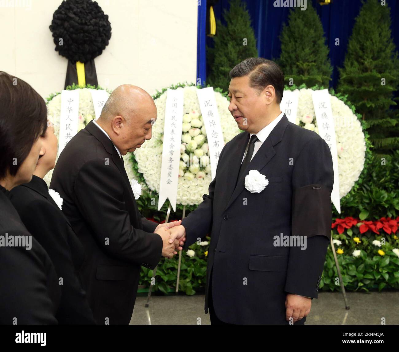 (170511) -- BEIJING, May 11, 2017 -- Chinese President Xi Jinping (R) shakes hands with a family member of Buhe, a former vice chairman of the Standing Committee of the National People s Congress (NPC), at the funeral of Buhe at the Babaoshan Revolutionary Cemetery in Beijing, capital of China, May 11, 2017. The cremation of Buhe was held Thursday in Beijing. Buhe died in Beijing on May 5. He was 91. President Xi Jinping, Premier Li Keqiang, and other senior leaders including Zhang Dejiang, Yu Zhengsheng, Liu Yunshan, Wang Qishan and Zhang Gaoli, as well as former leader Hu Jintao attended the Stock Photo