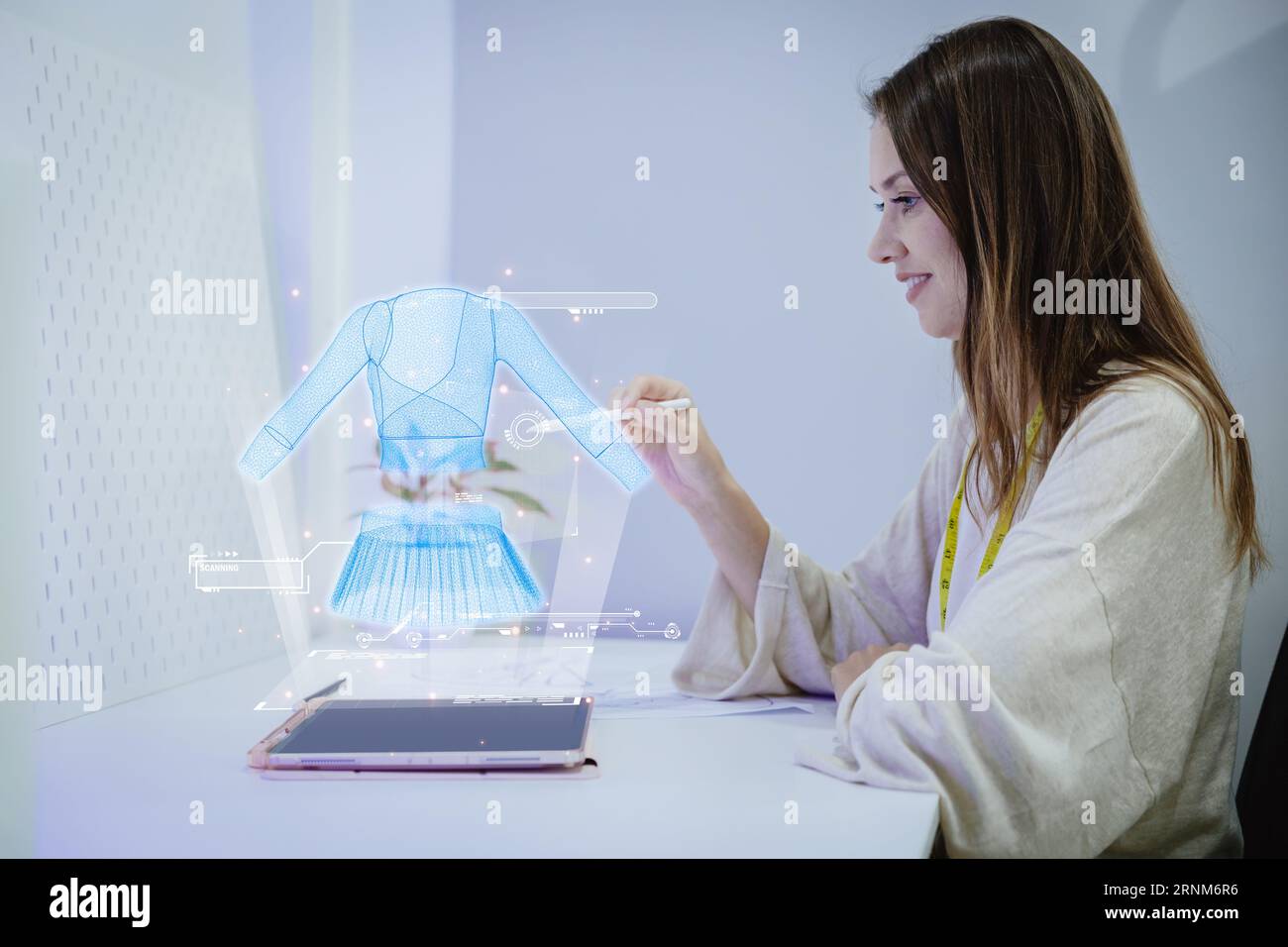 Costume fashion clothing designer using 3D hologram VR visual digital design technology in tailor studio Stock Photo