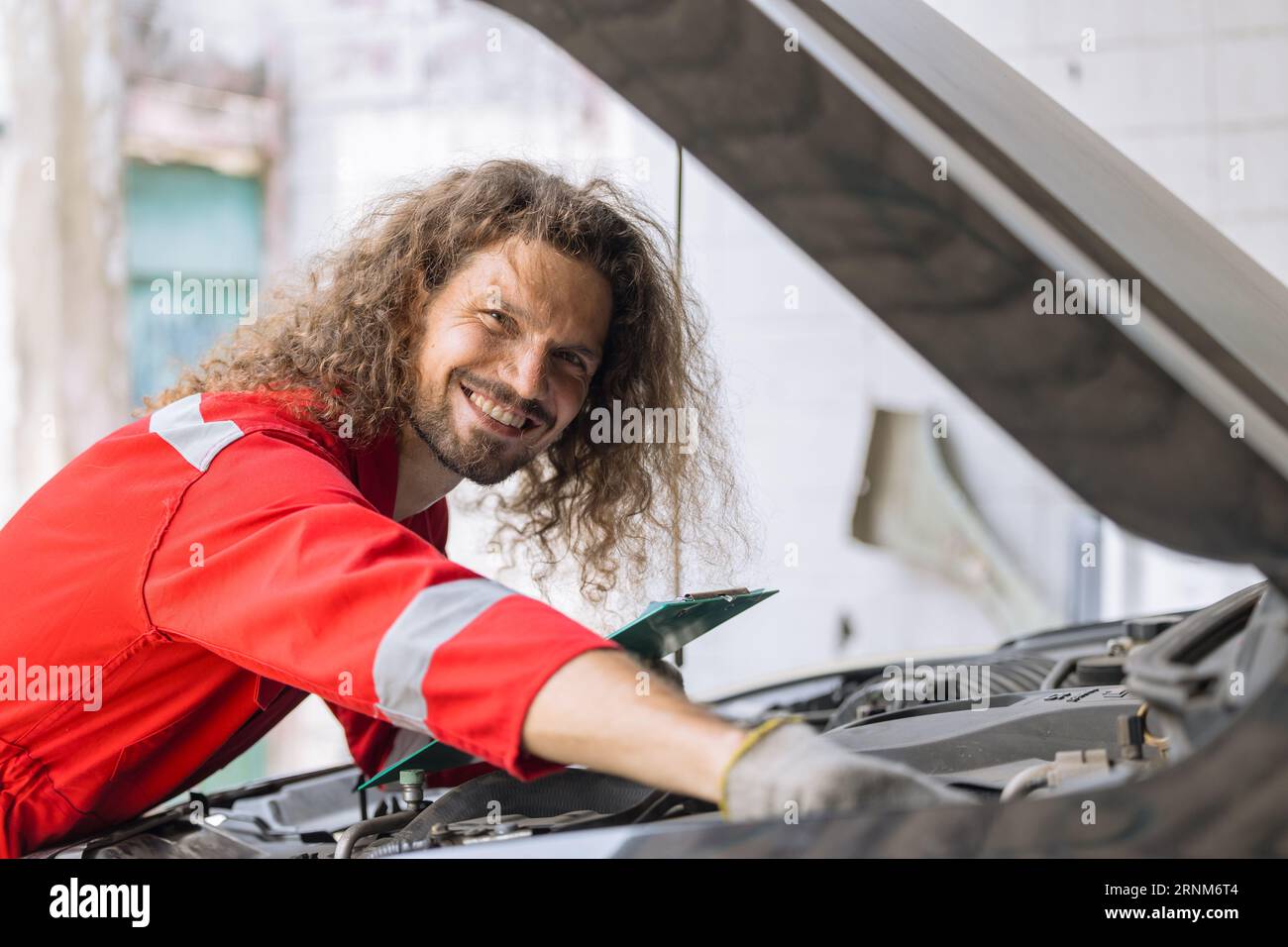 portrait happy garage mechanic male worker working fix service maintenance auto vehicle engine Stock Photo