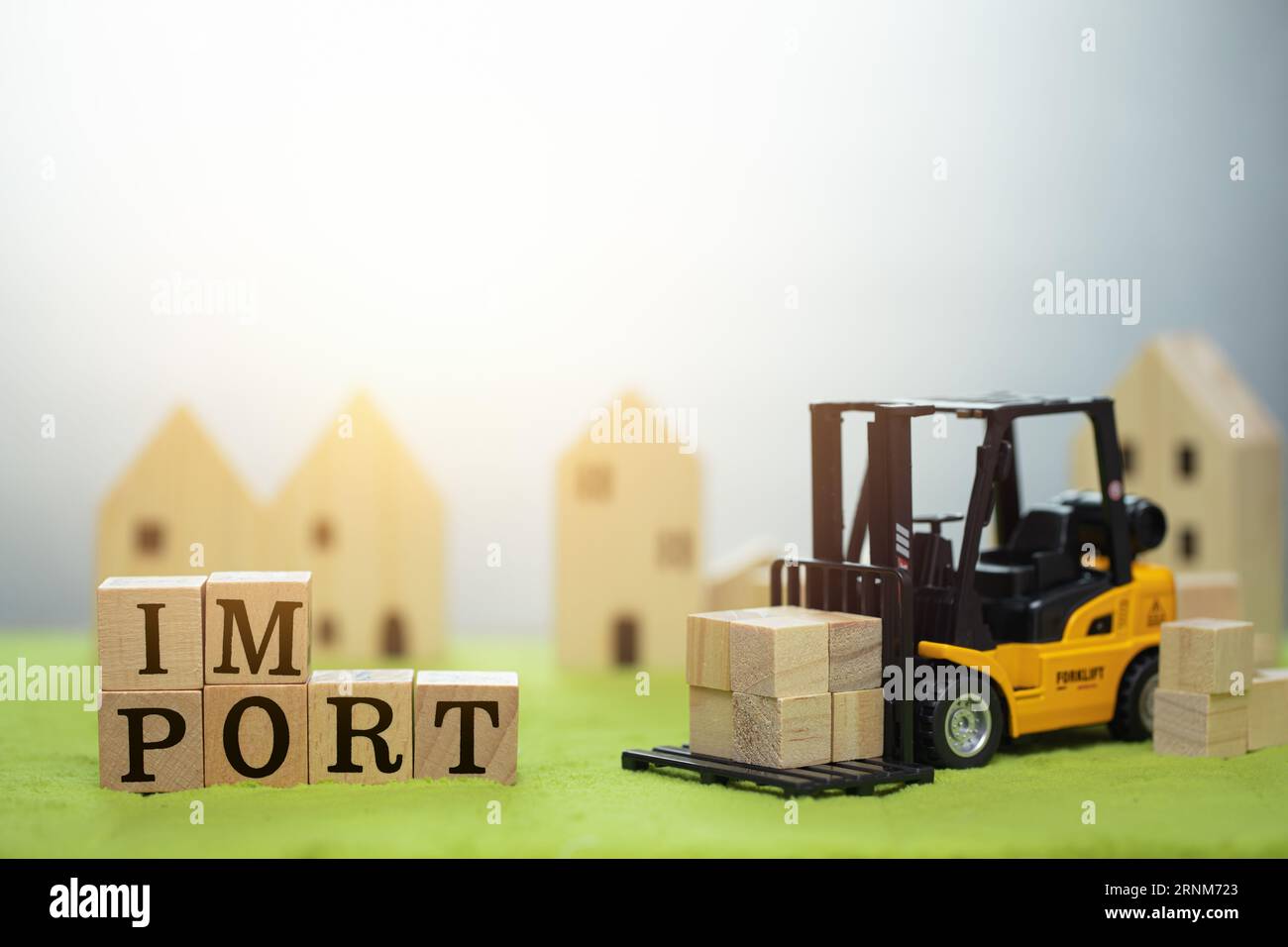 forklift truck with wood block with word IMPORT toy decoration for import shipping cargo concept Stock Photo