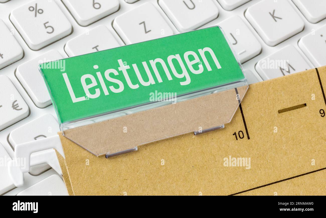 A brown file folder labeled Services in german - Leistungen Stock Photo