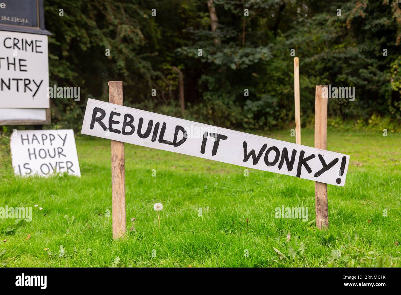 Himley, Staffordshire, UK. 2nd Sep, 2023. Four weeks after the famous Crooked House pub burned down, protest signs and the Black Country's flag are displayed in support of re-building the landmark building in the same location. A sign reads Rebuild it Wonky! Credit: Peter Lopeman/Alamy Live News Stock Photo