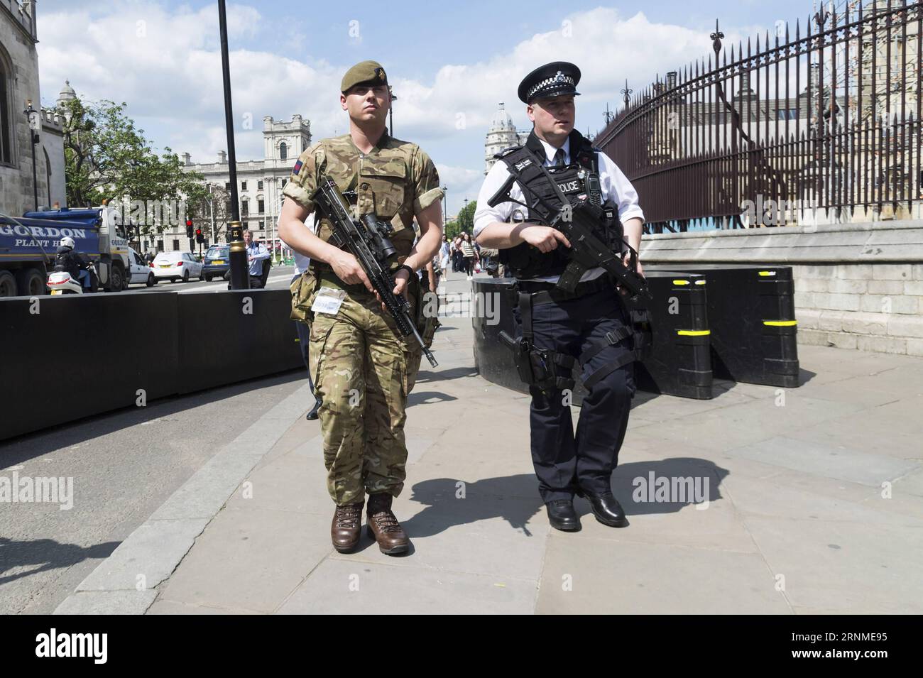 Armed police patrol outside the houses of parliament in london hi-res ...