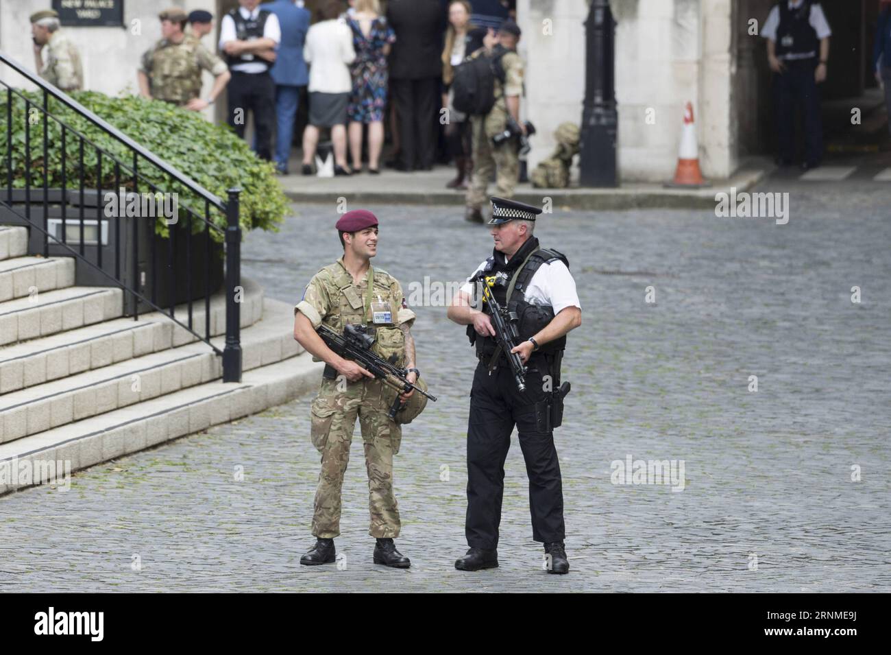 Armed police patrol outside the houses of parliament in london hi-res ...
