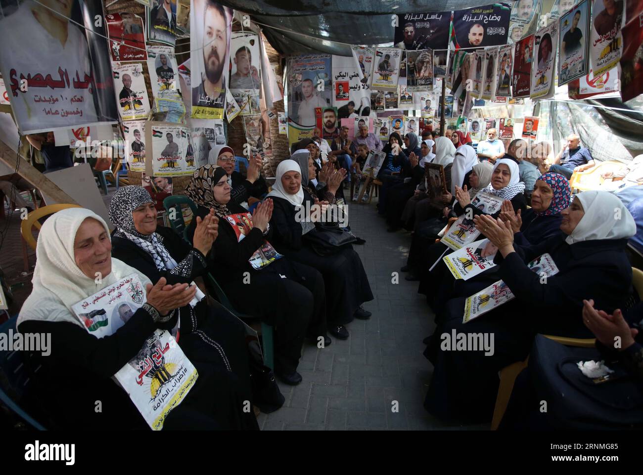 (170527) -- NABLUS, May 27, 2017 -- Palestinian women hold pictures of their jailed families, as they celebrate during a protest in solidarity with prisoners in Israeli jails, in the West Bank City of Nablus, on May 27, 2017. Palestinian Fatah Party Recruitment Commissioner Jamal Muheisen declared that over 1,500 Palestinian prisoners in Israeli jails have suspended their hunger strike after a deal with the Israeli Prisons Authority. )(yk) MIDEAST-NABLUS-PRISONERS AymanxNobani PUBLICATIONxNOTxINxCHN   Nablus May 27 2017 PALESTINIAN Women Hold Pictures of their jailed families As They Celebrate Stock Photo